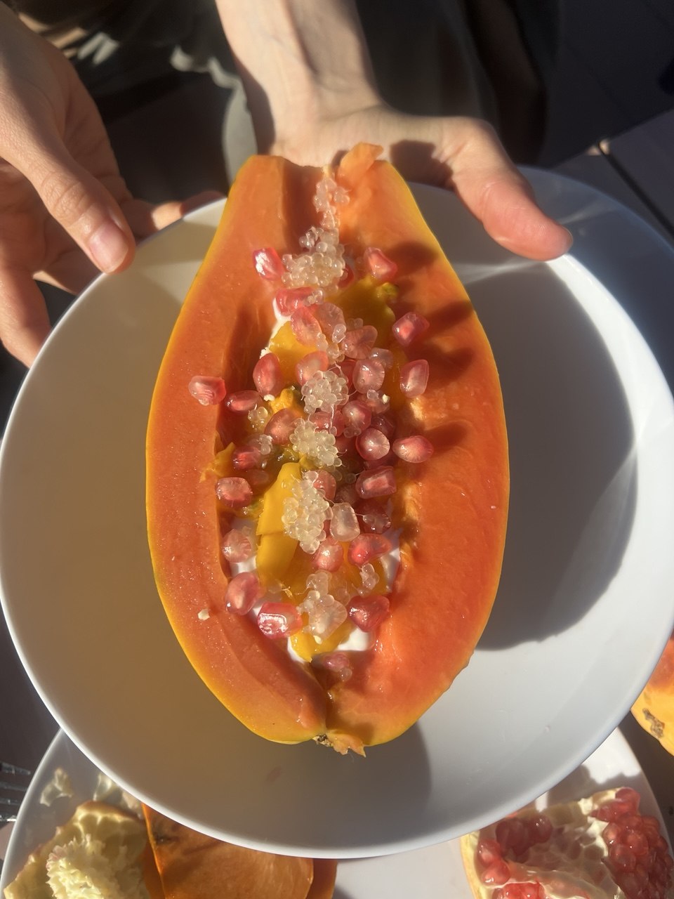 Une papaye garnie de graines de grenade et de citron caviar